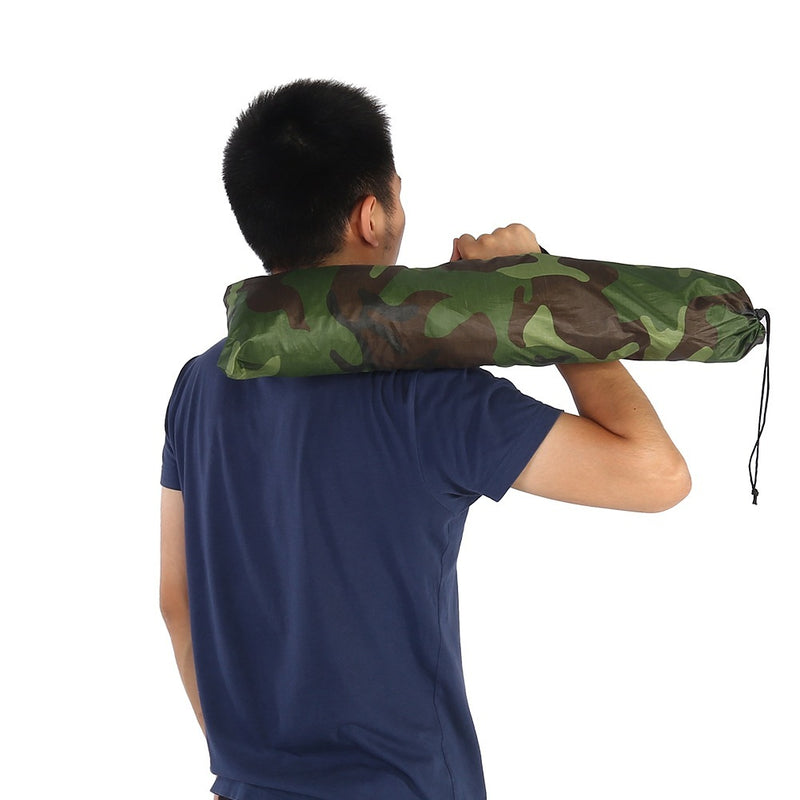Load image into Gallery viewer, Person carrying a rolled-up camouflage mat on their shoulder against a white background
