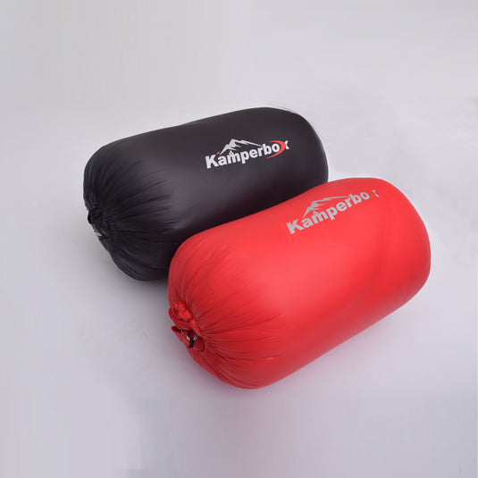 Black and red sleeping bags with Kamperbox logo on a light gray background