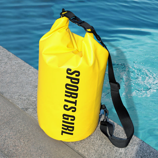 Yellow waterproof bag with 'SPORTS GIRL' text by a pool