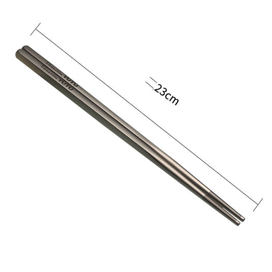 Pair of silver chopsticks with measurements on a white background
